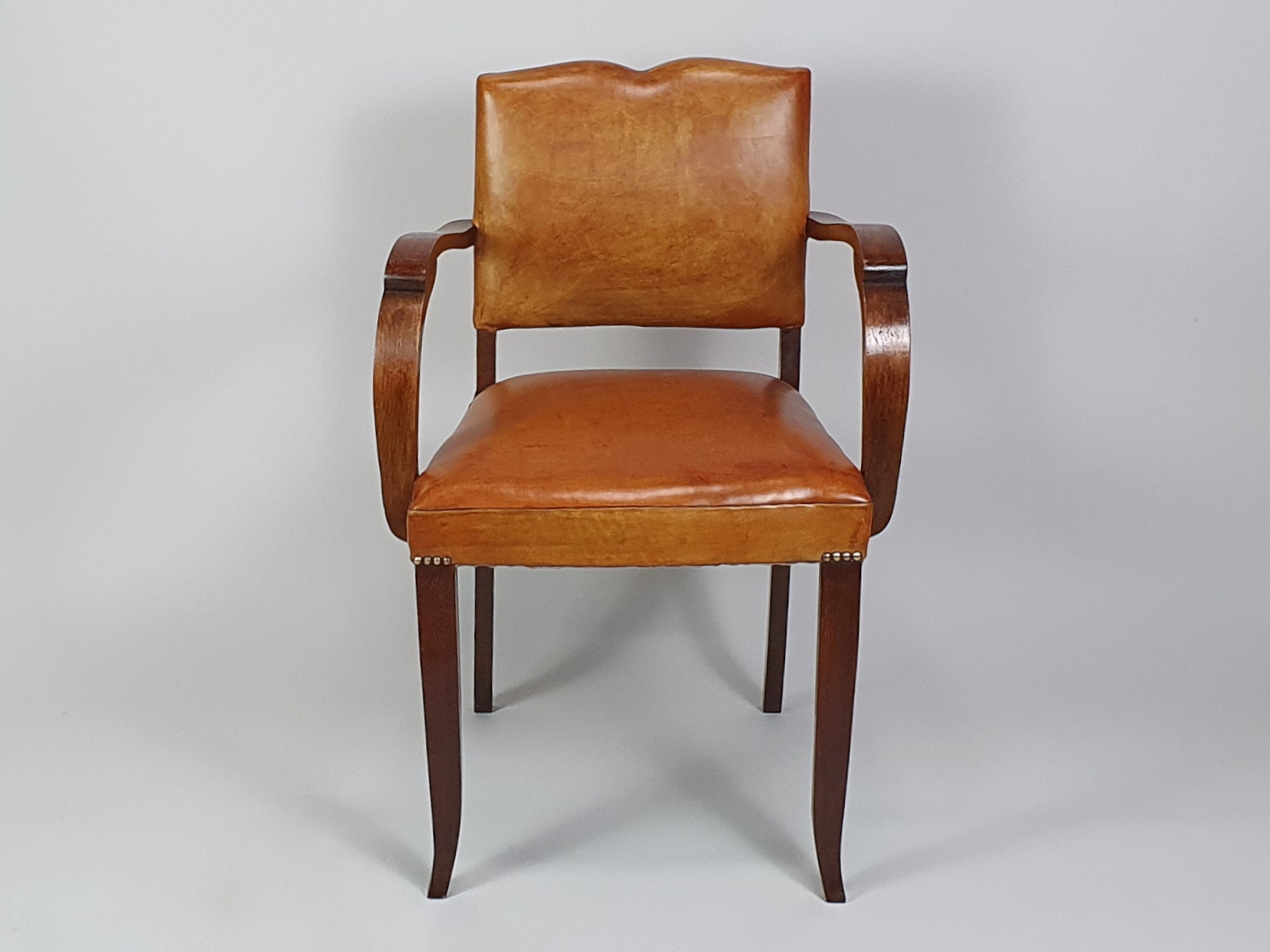 Pair of French leather moustache bridge chairs