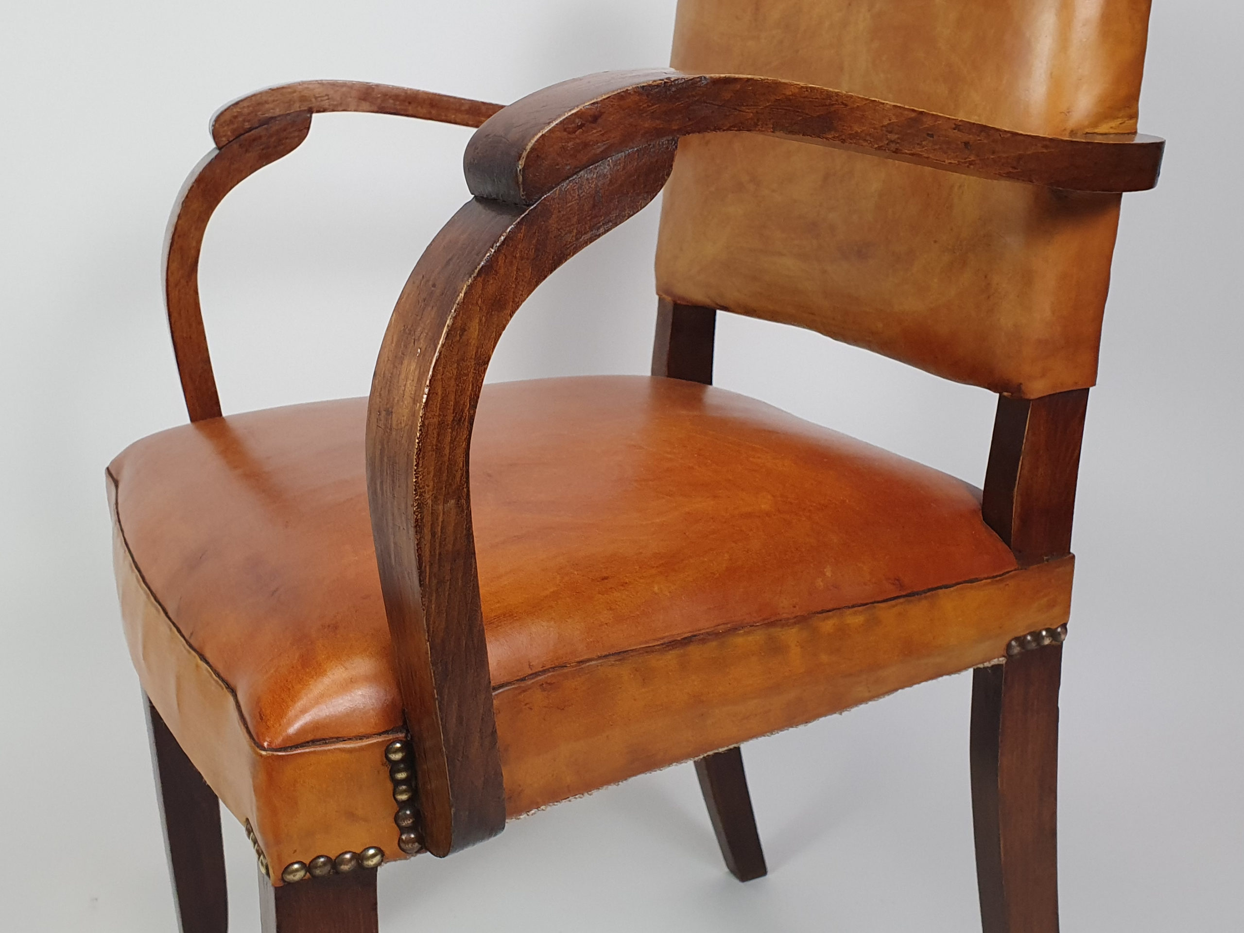 Pair of French leather moustache bridge chairs