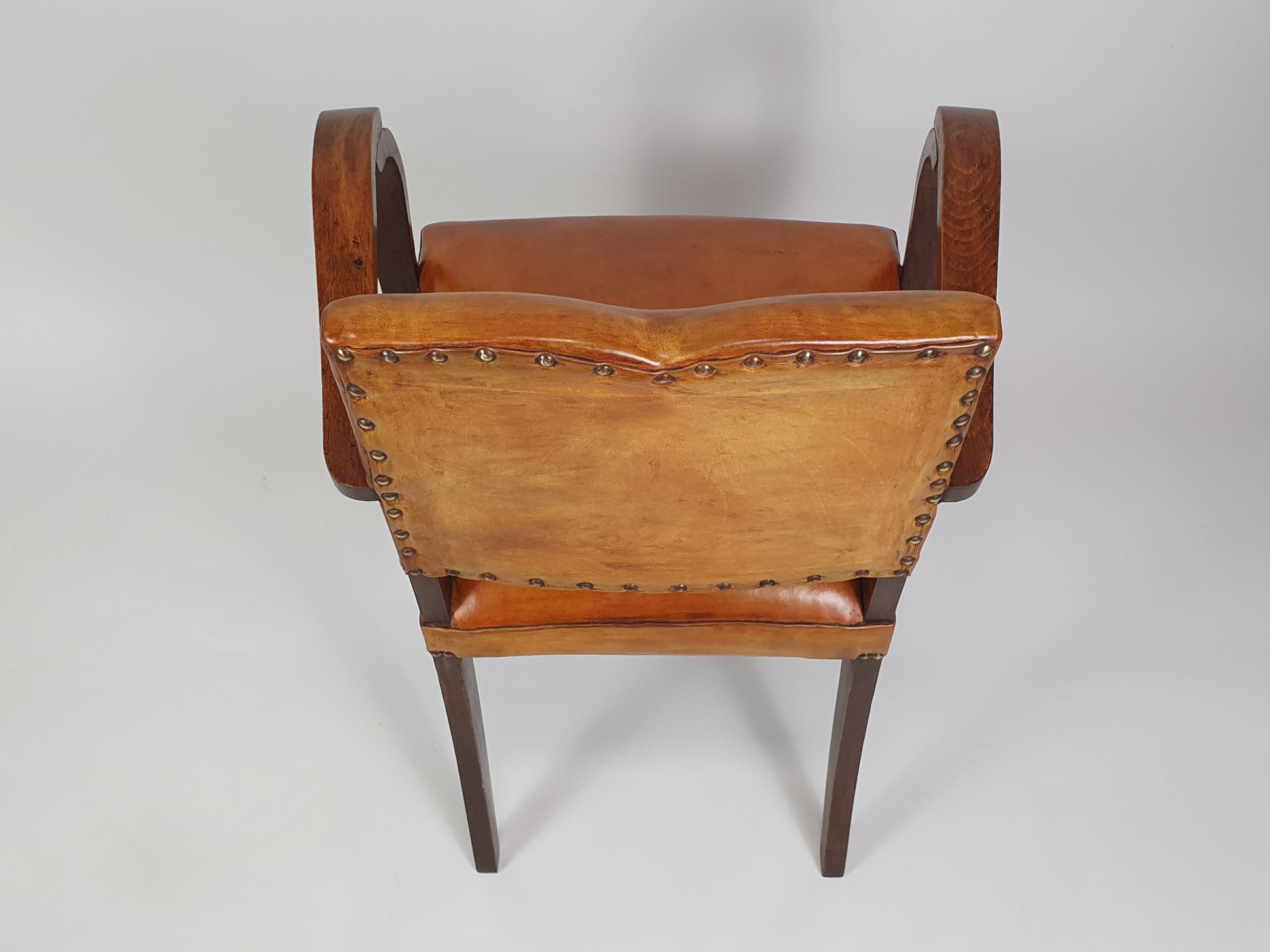 Pair of French leather moustache bridge chairs