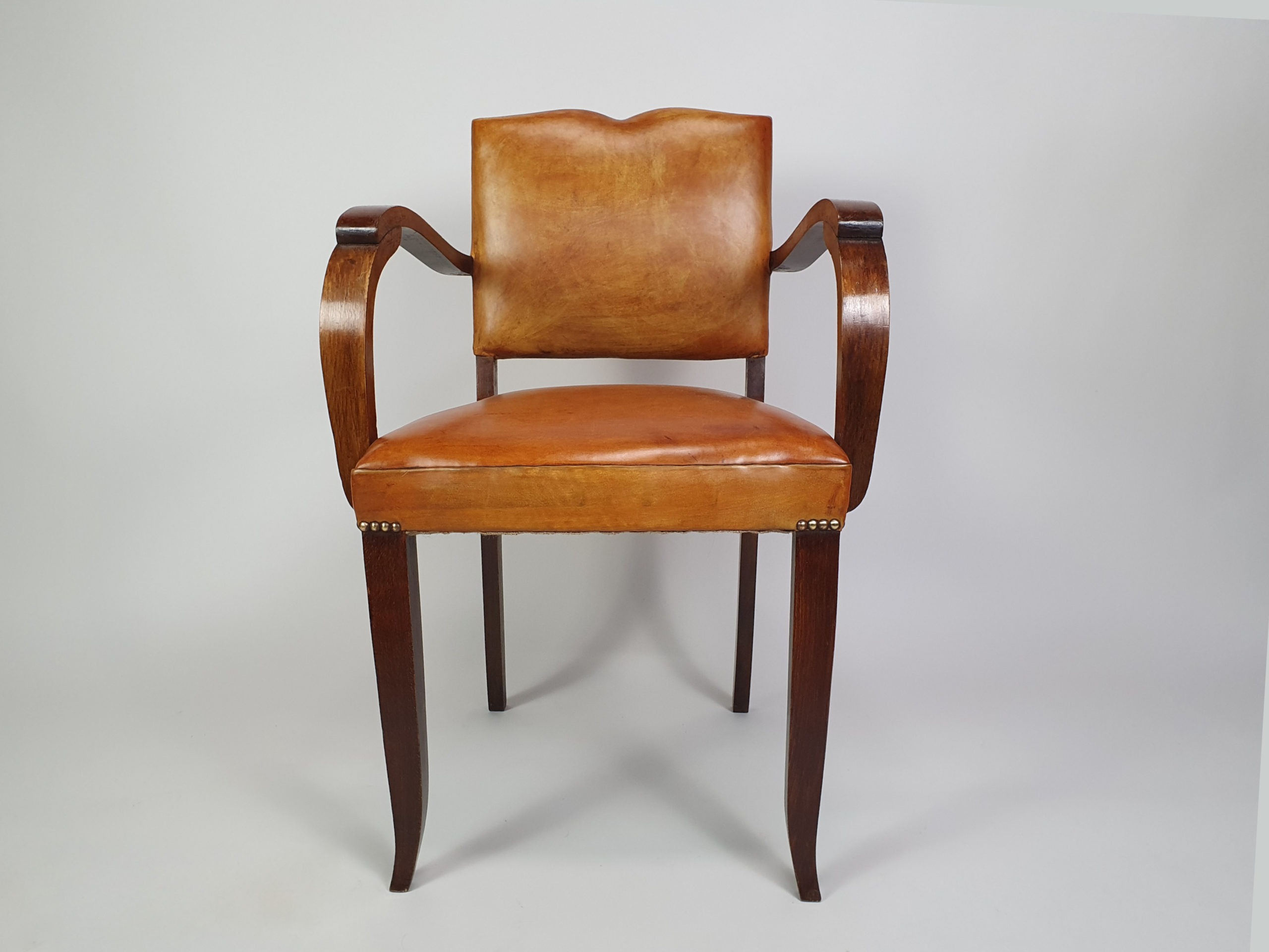 Pair of French leather moustache bridge chairs