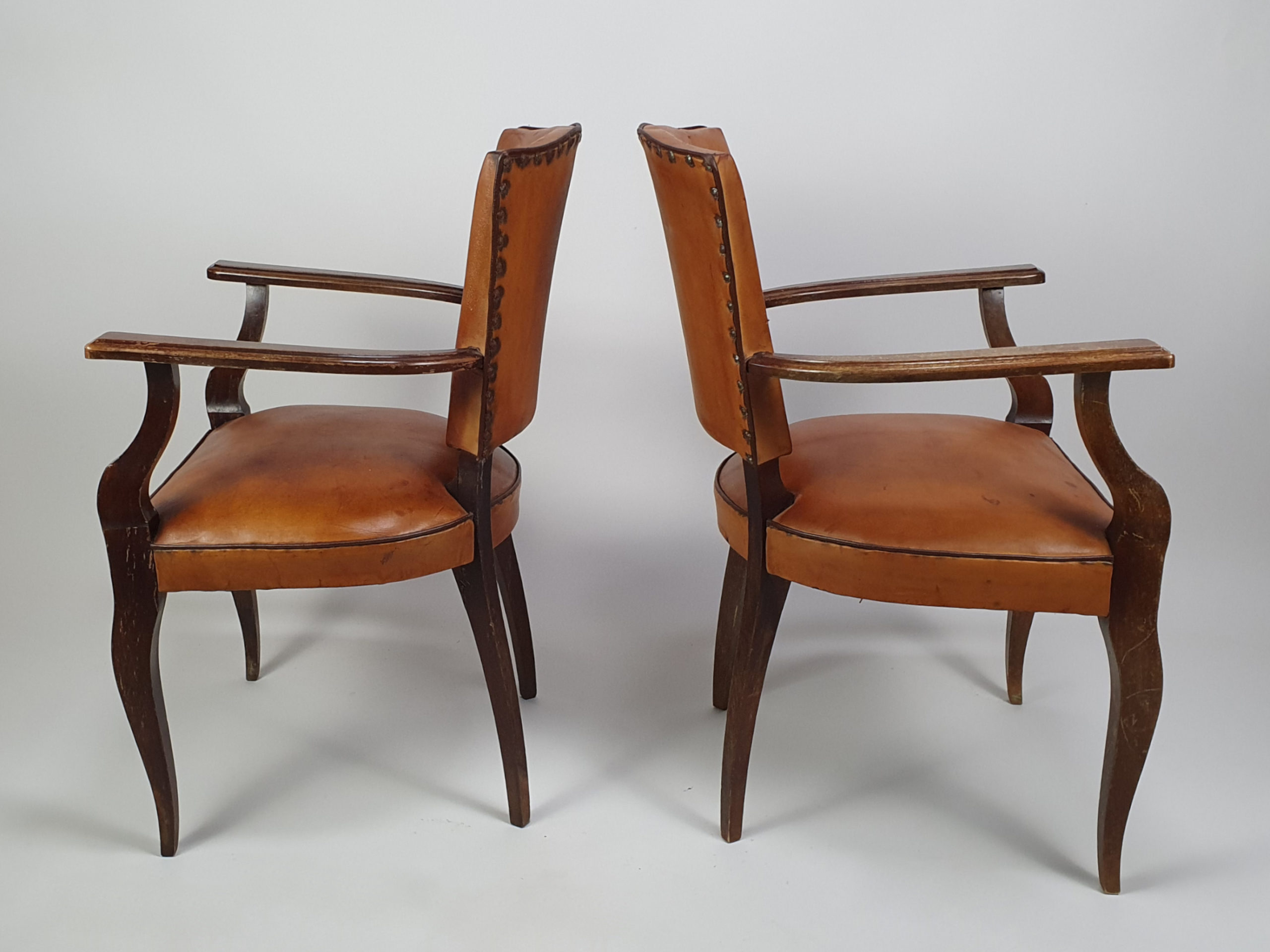A pair of 20th century antique leather moustache Chairs