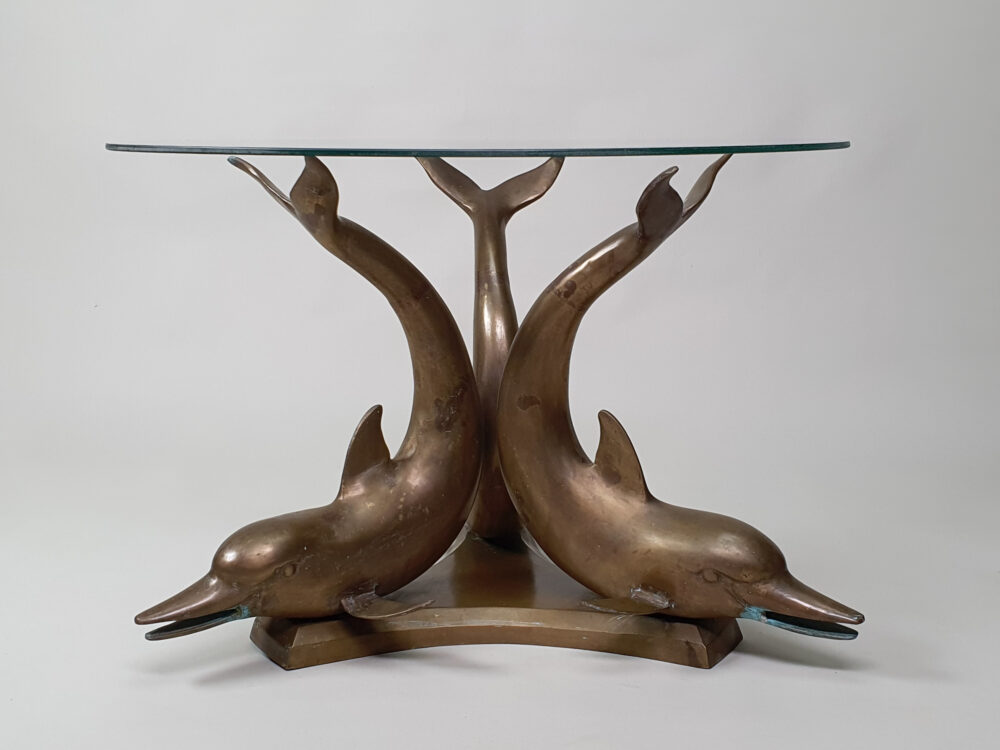 A mid century antique brass & glass Dolphin Table with a glass top