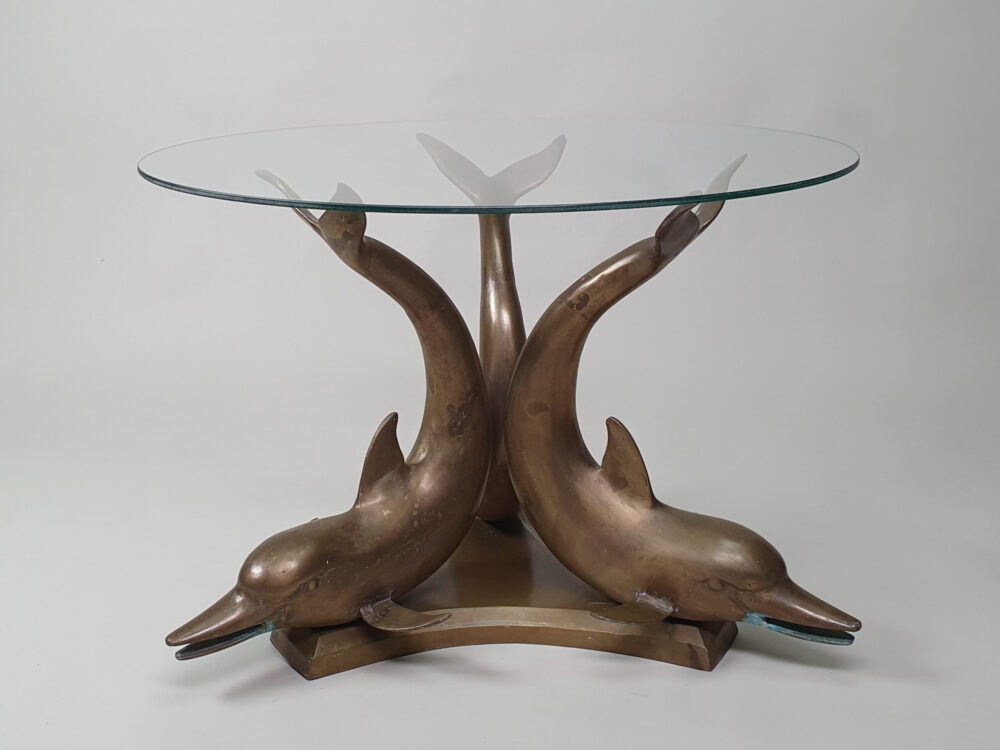 A mid century antique brass & glass Dolphin Table with a glass top