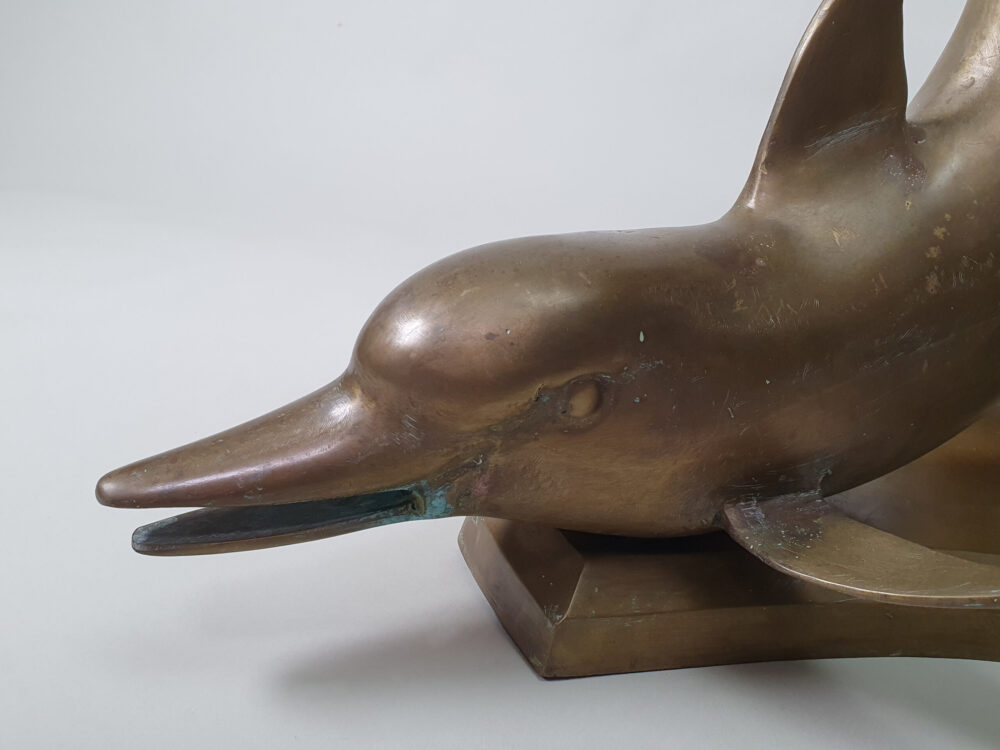 A mid century antique brass & glass Dolphin Table with a glass top