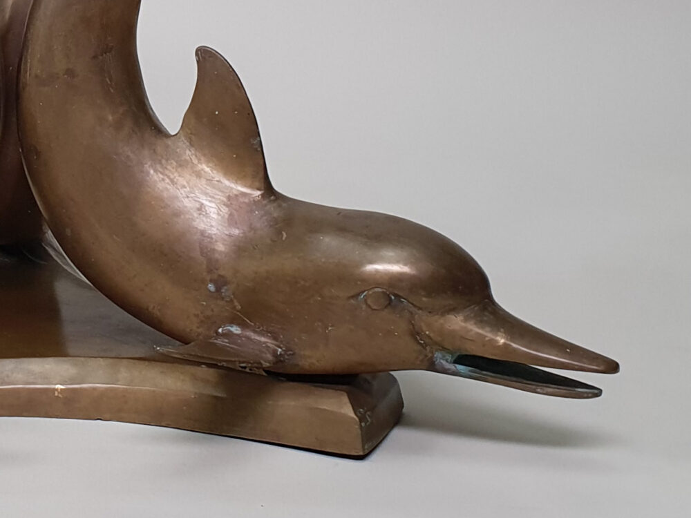 A mid century antique brass & glass Dolphin Table with a glass top
