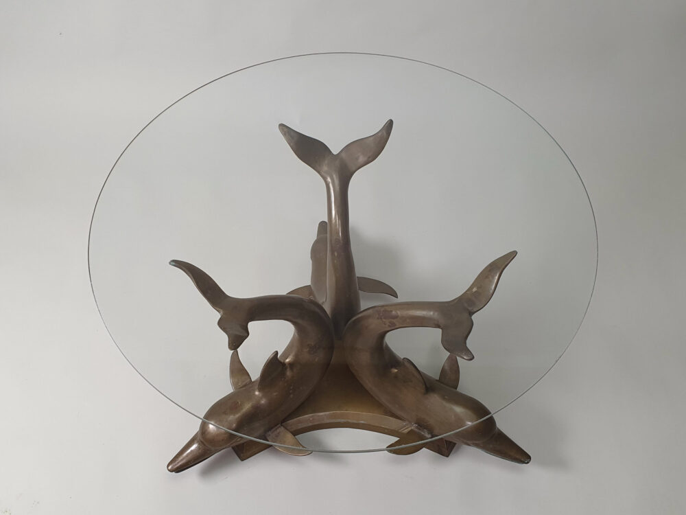 A mid century antique brass & glass Dolphin Table with a glass top