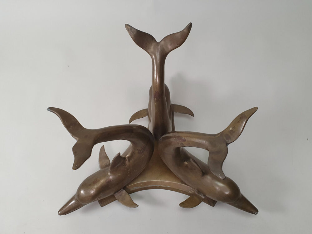 A mid century antique brass & glass Dolphin Table with a glass top