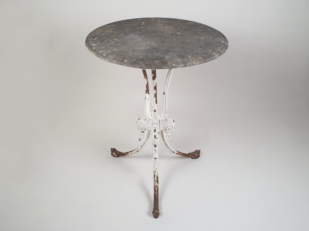 Circular Victorian garden table with an ornate cast iron base and bevelled marble top