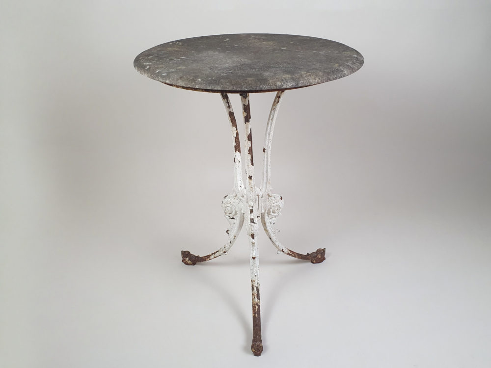 Circular Victorian garden table with an ornate cast iron base and bevelled marble top