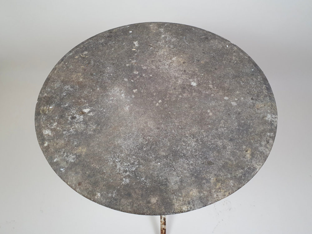 Circular Victorian garden table with an ornate cast iron base and bevelled marble top