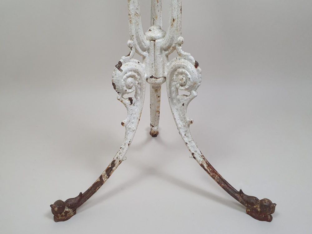 Circular Victorian garden table with an ornate cast iron base and bevelled marble top