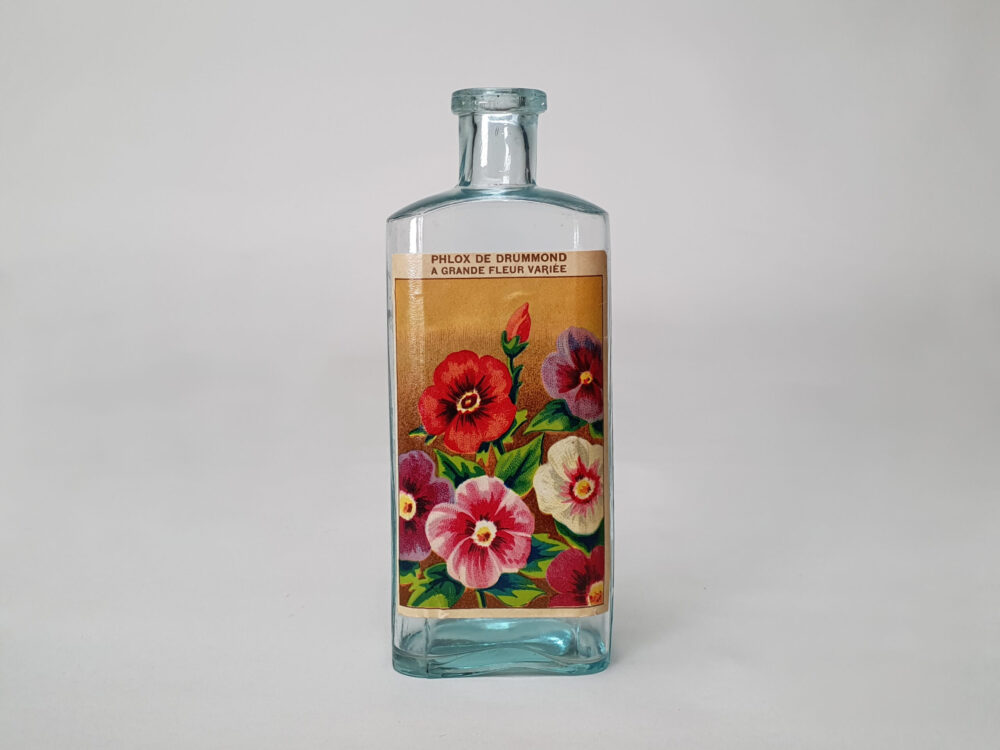 Collection of decorative antique bottles with old French flower labels