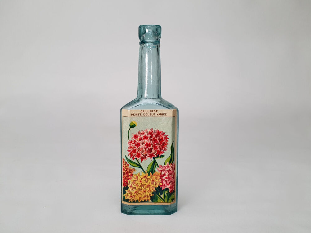 Collection of decorative antique bottles with old French flower labels