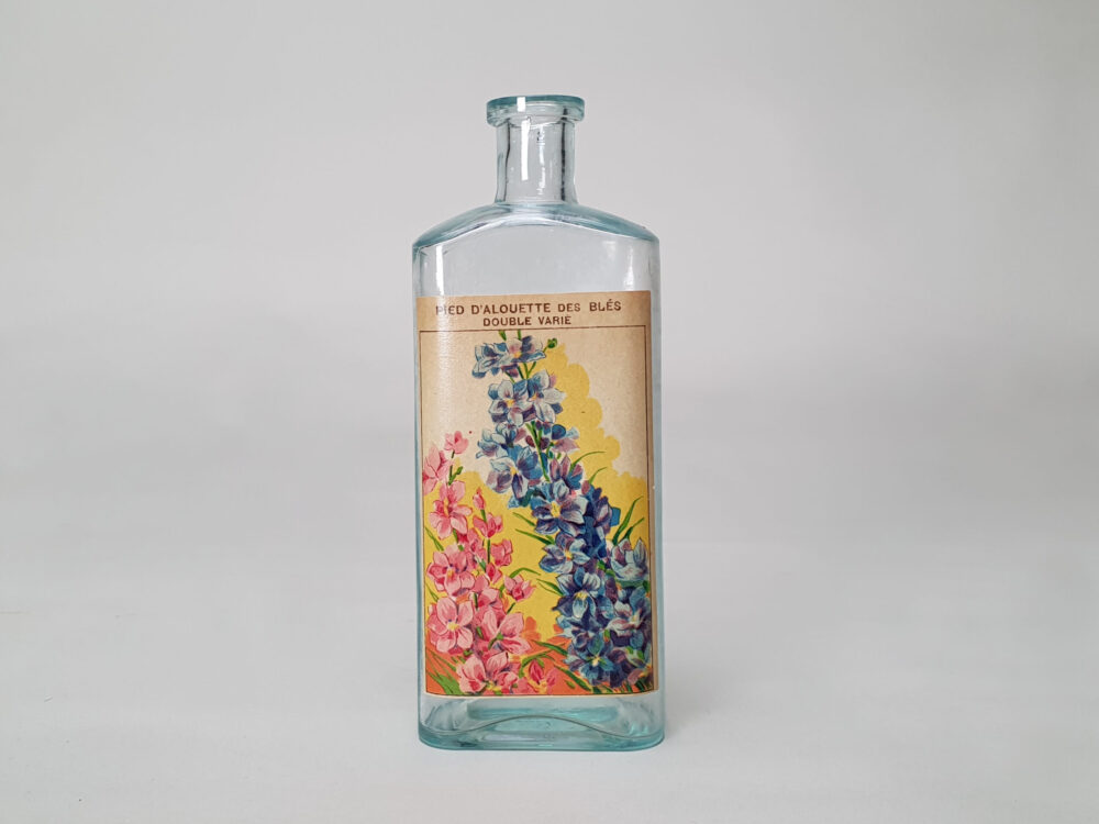 Collection of decorative antique bottles with old French flower labels