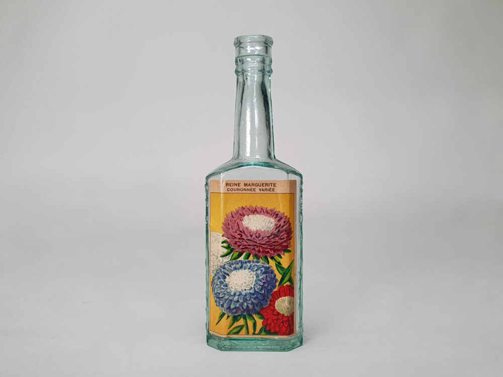 Collection of decorative antique bottles with old French flower labels