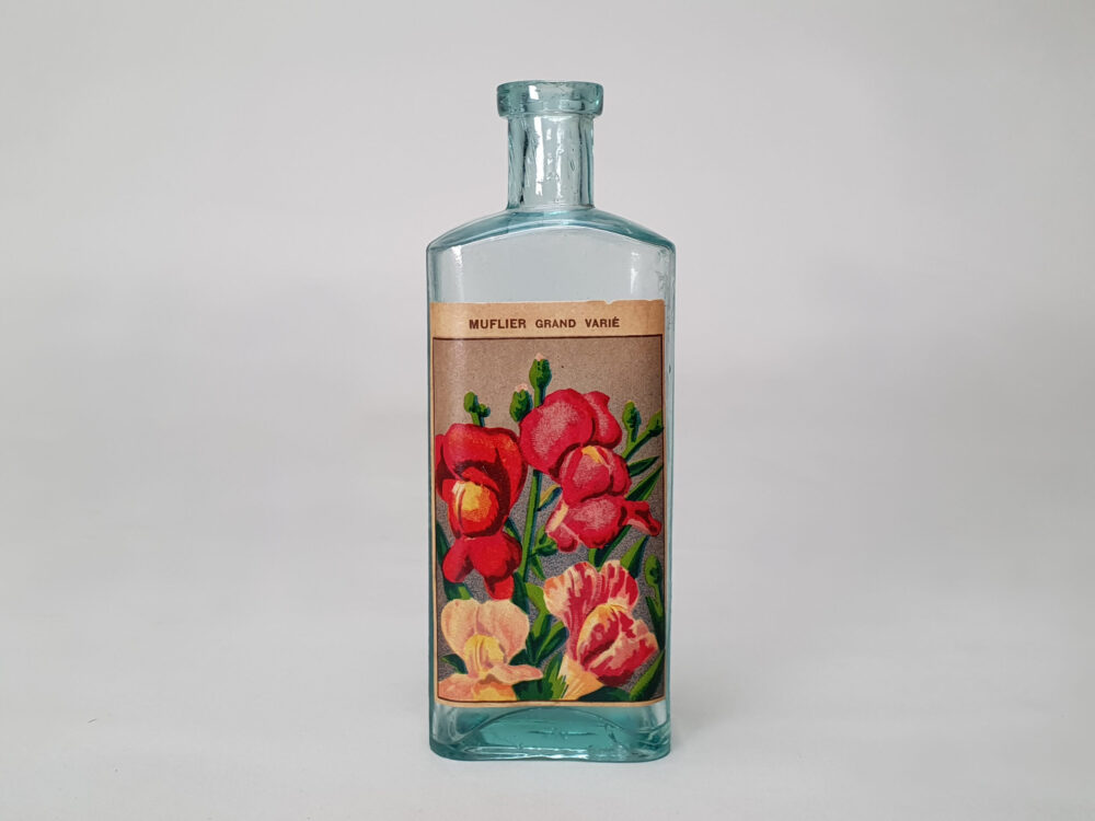 Collection of decorative antique bottles with old French flower labels