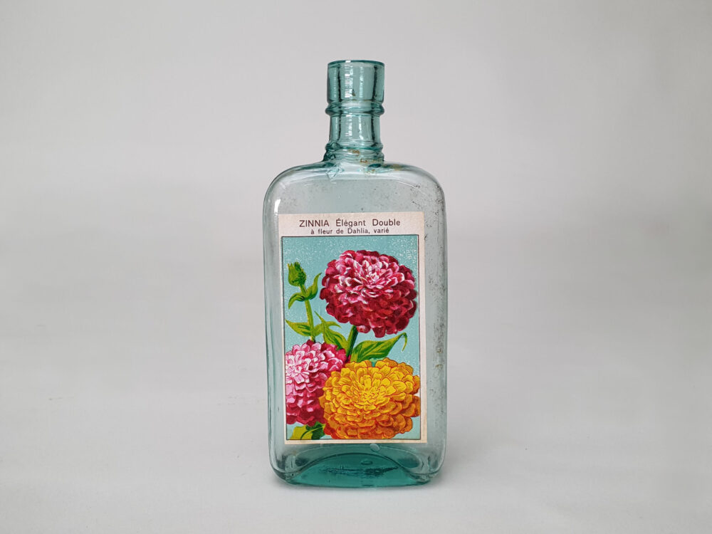 Collection of decorative antique bottles with old French flower labels