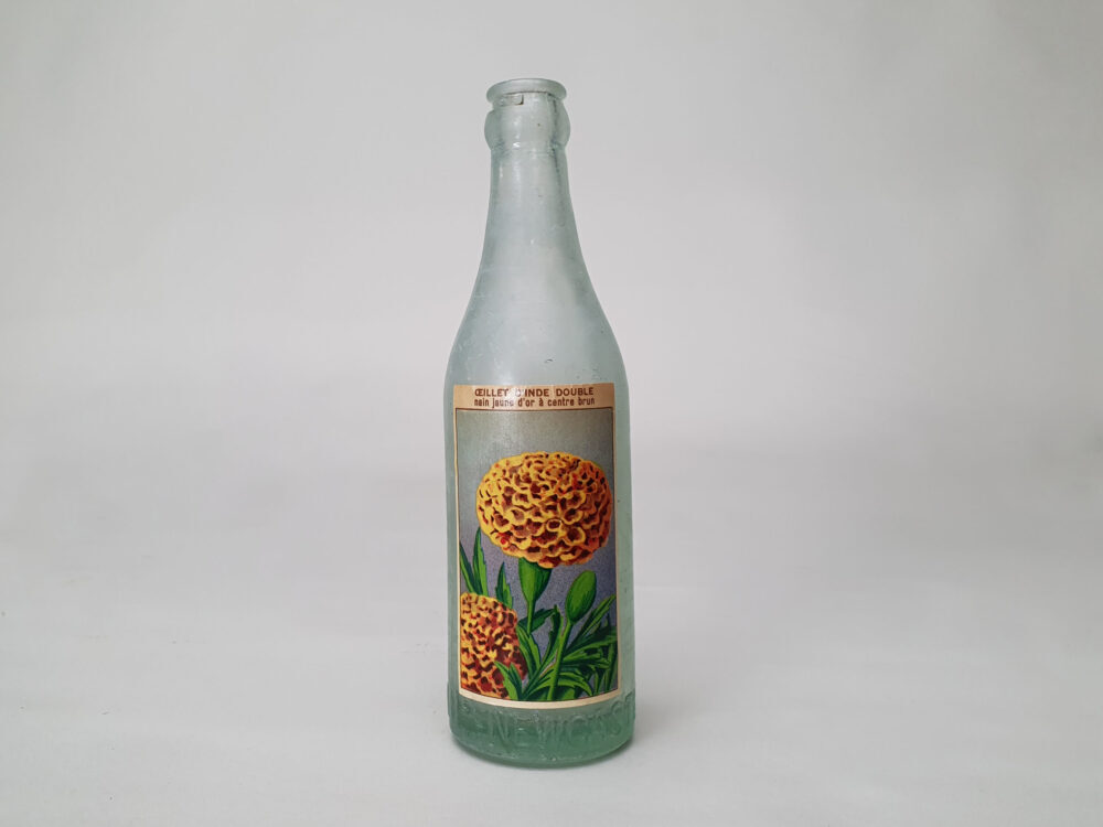 Collection of decorative antique bottles with old French flower labels