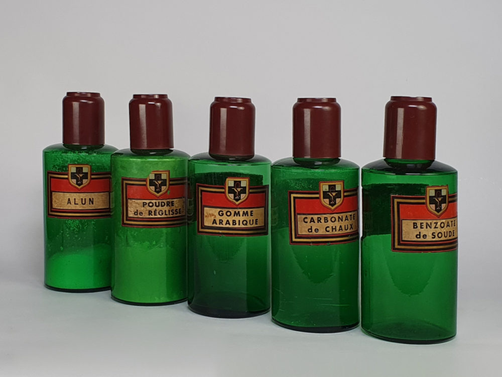 Decorative antique green French Pharmacy Bottles with porcelain labels
