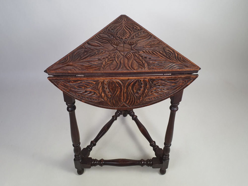 Early 1900s antique oak carved Cricket Table with drop leaf sides