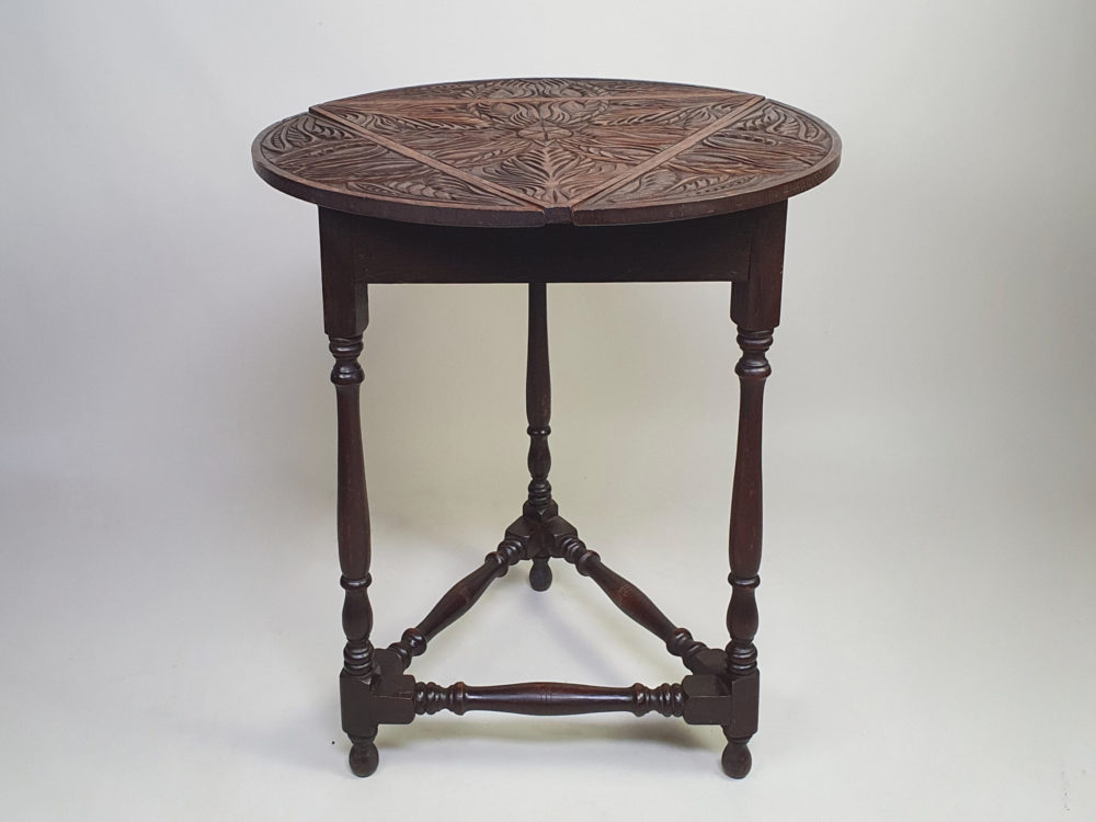 Early 1900s antique oak carved Cricket Table with drop leaf sides