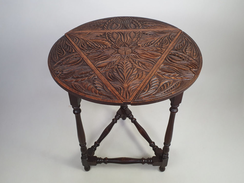Early 1900s antique oak carved Cricket Table with drop leaf sides