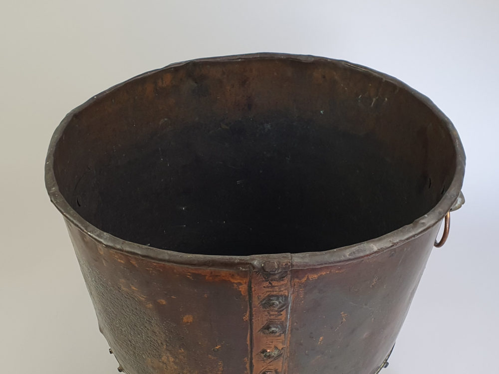 Large rivetted Copper Log Basket with lions head handles and raised paw feet