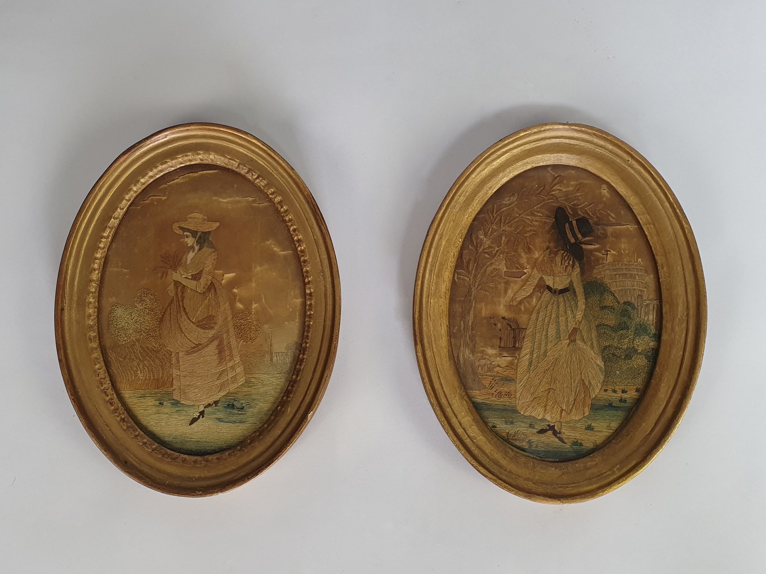Pair of 19th century antique Georgian Silk Work Ladies in oval frames