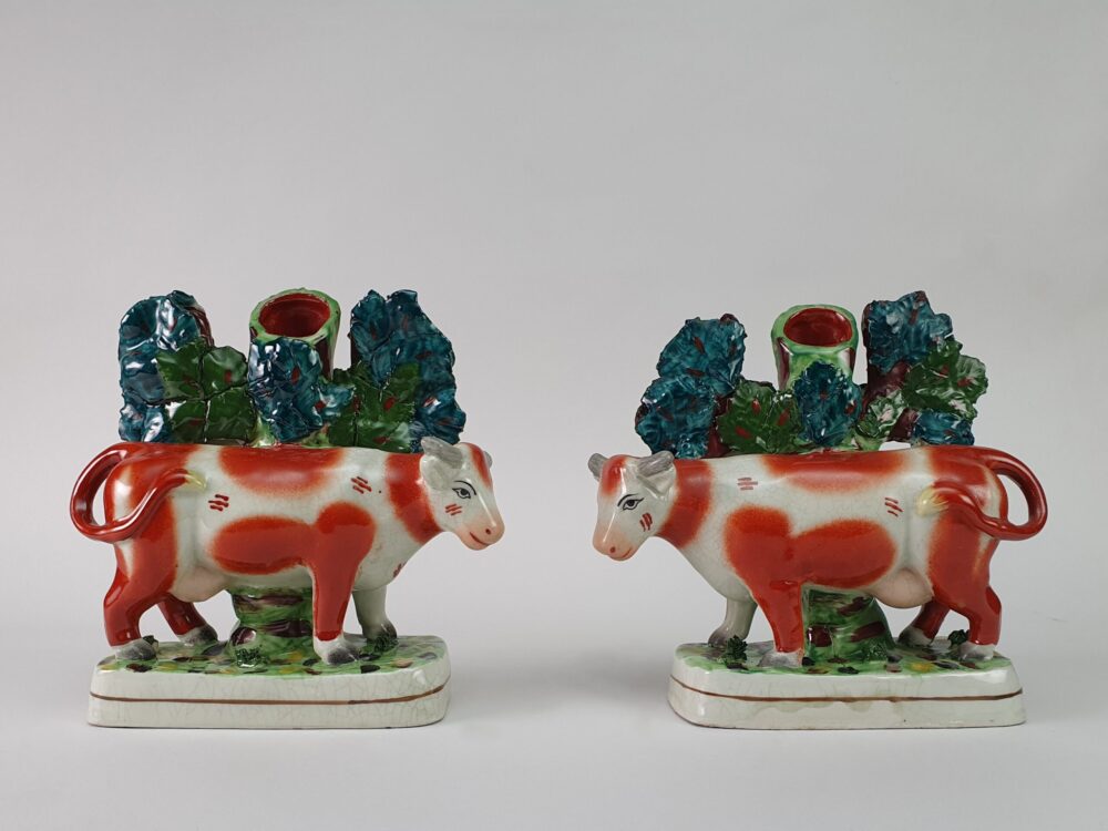 Pair of mid century antique Staffordshire slipware pottery Cows