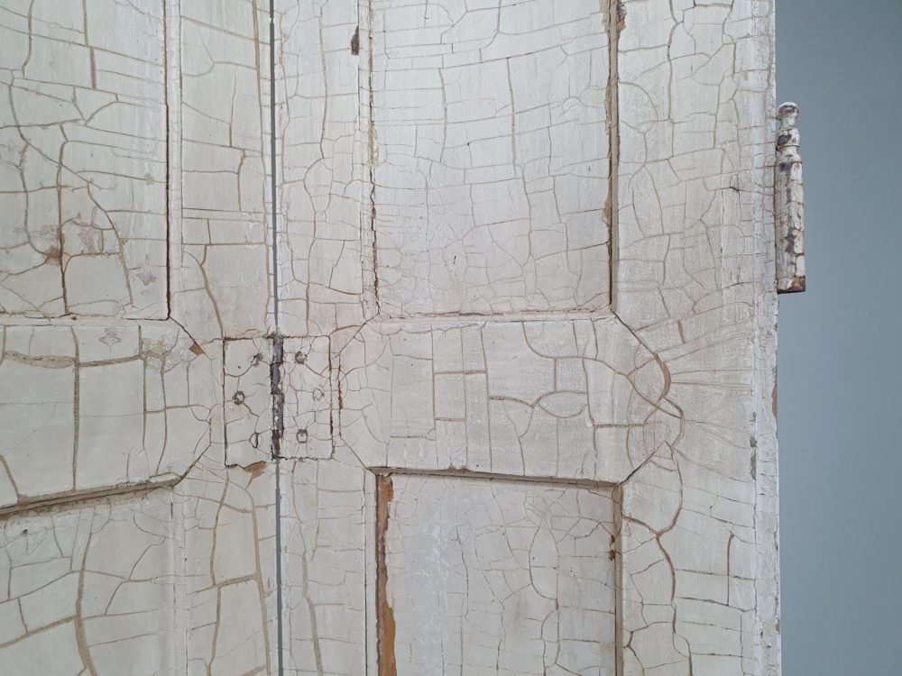 Two pairs of tall panelled antique Shutters in original cream paint