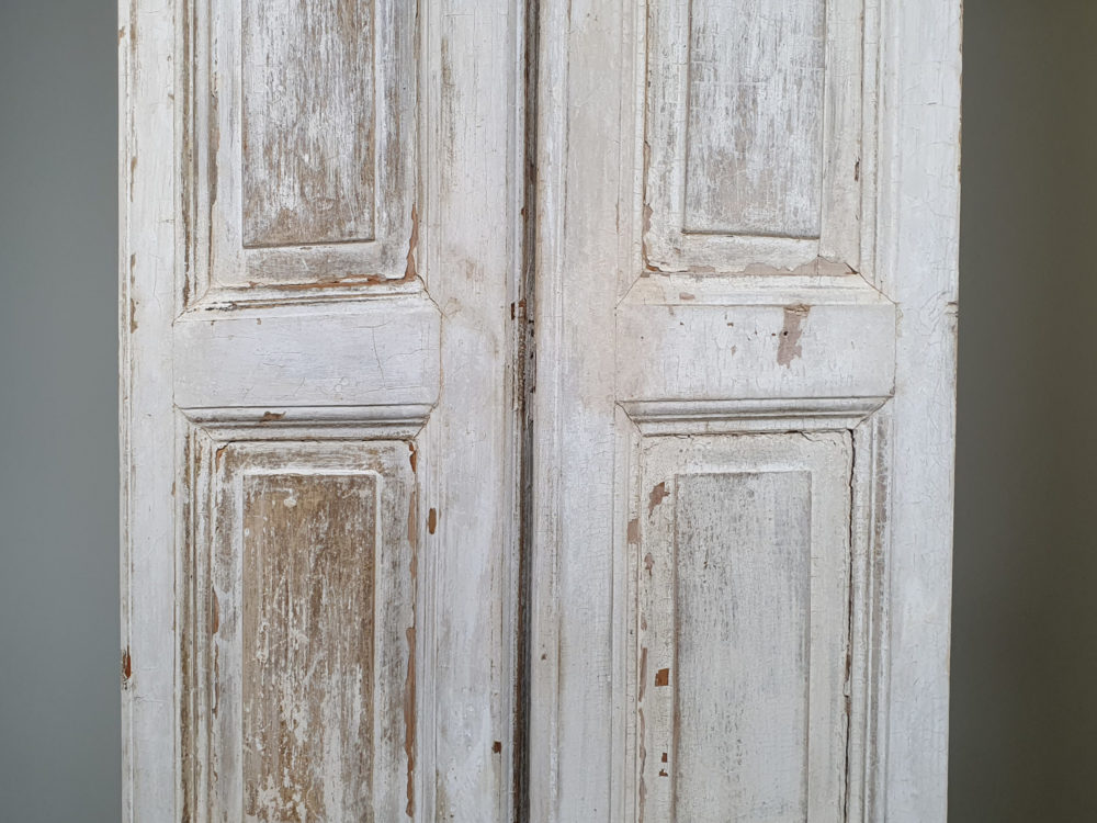 Two pairs of tall panelled antique Shutters in original cream paint