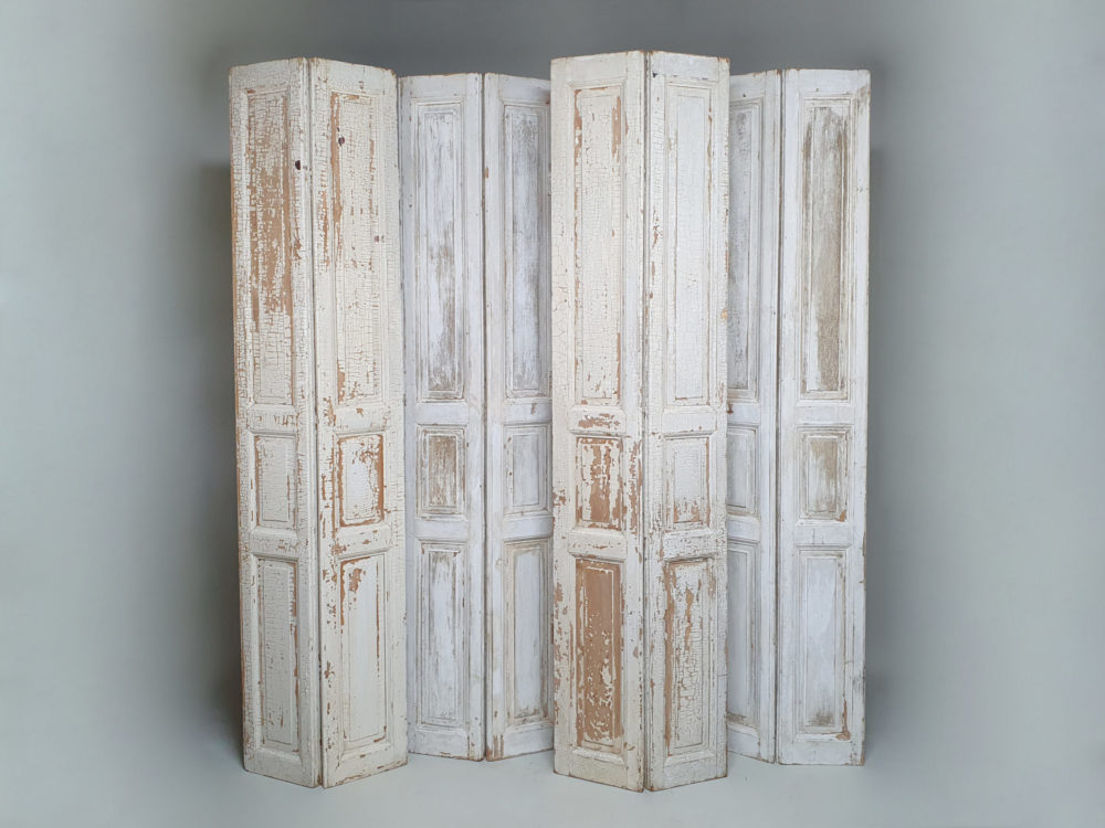 Two pairs of tall panelled antique Shutters in original cream paint