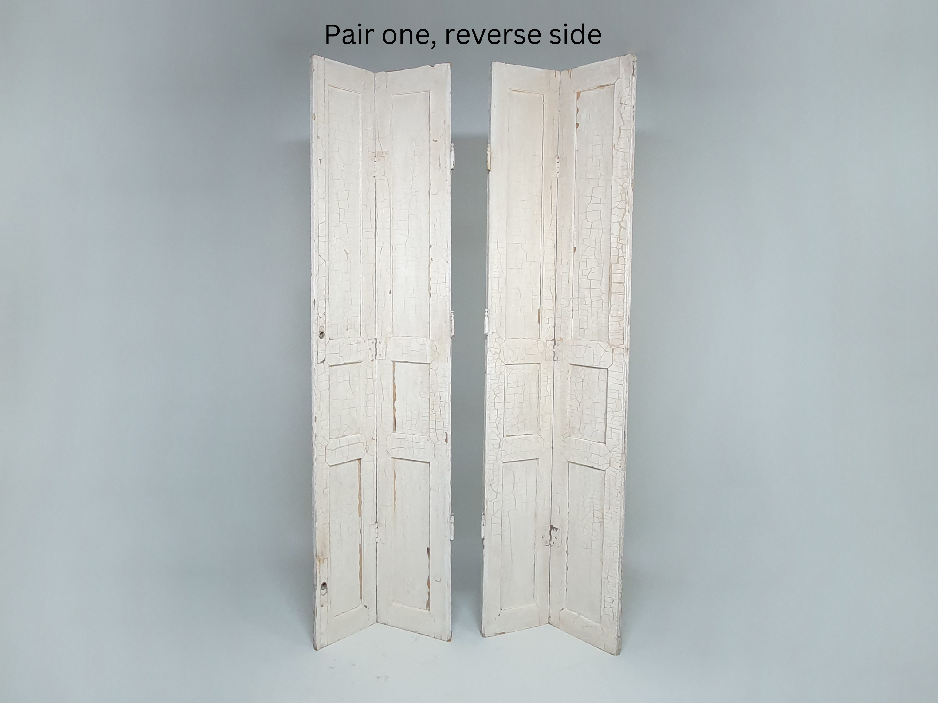 Two pairs of tall panelled antique Shutters in original cream paint