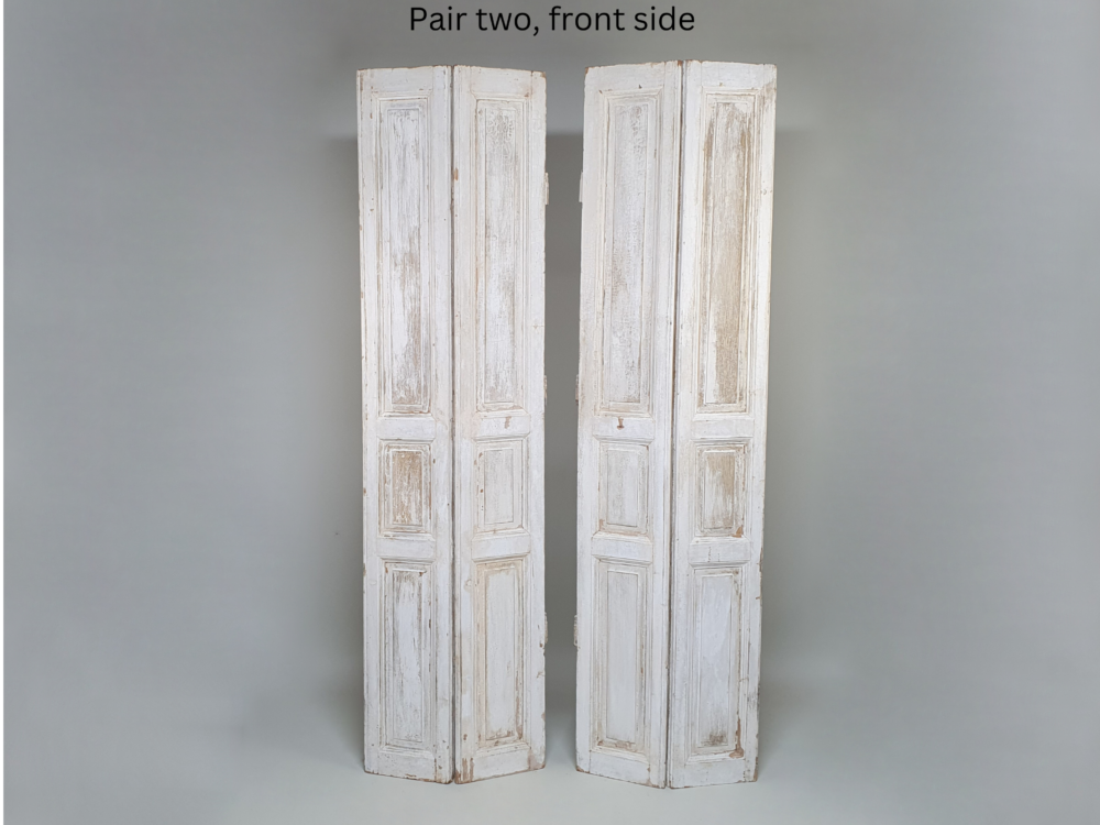 Two pairs of tall panelled antique Shutters in original cream paint