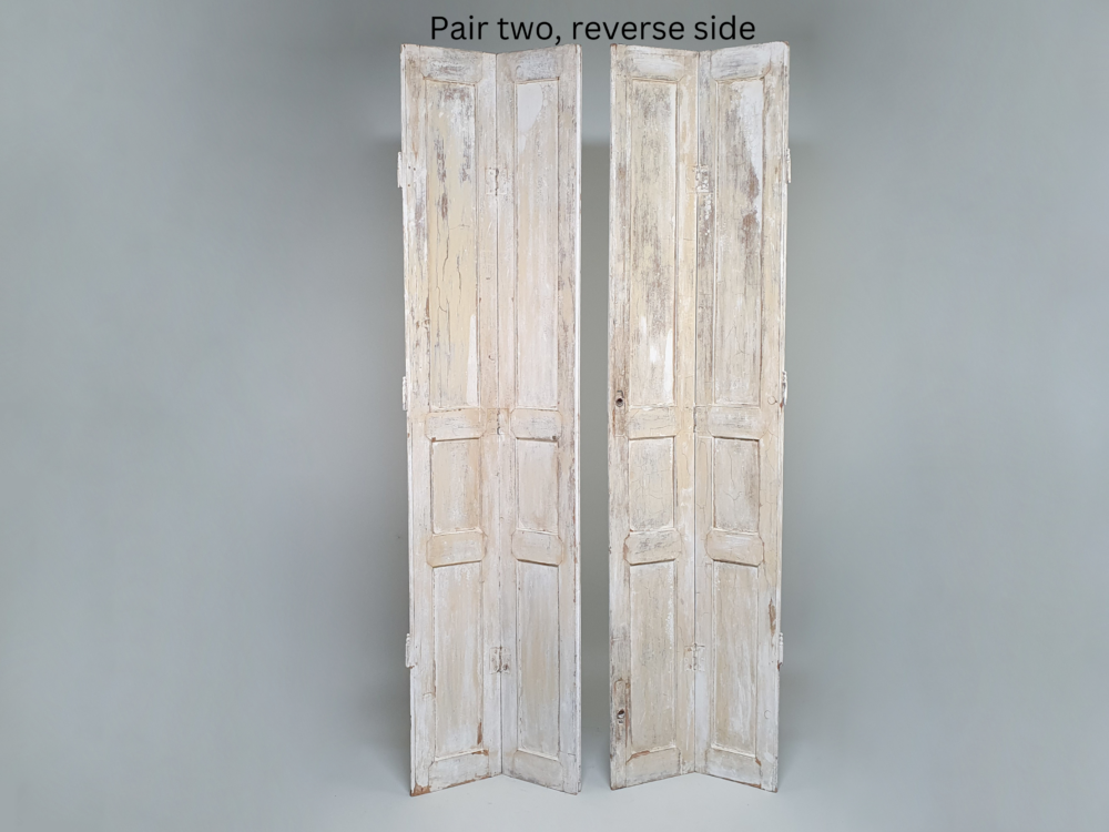 Two pairs of tall panelled antique Shutters in original cream paint