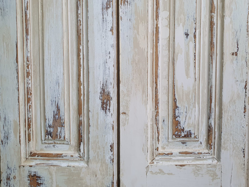 Pair of antique panelled Shutters in original cream paint