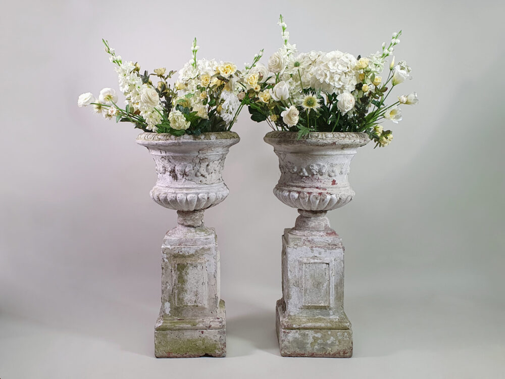 Pair of tall well weathered antique Garden Urns on Plinths