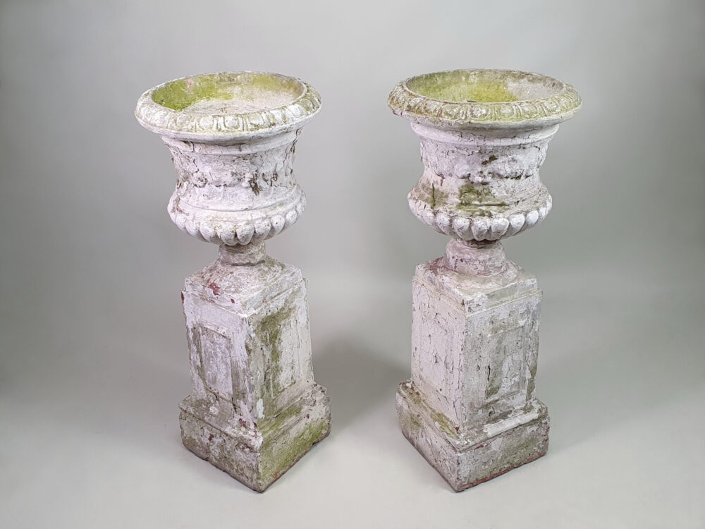 Pair of tall well weathered antique Garden Urns on Plinths