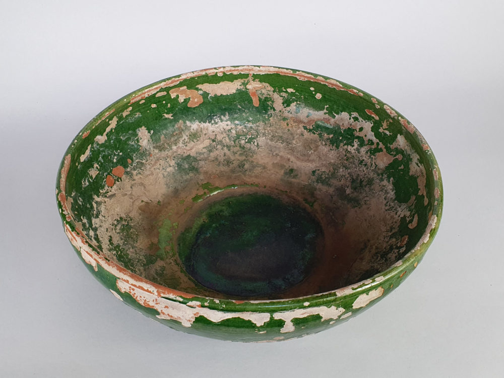 Rustic antique pottery Bowl with a worn green glaze