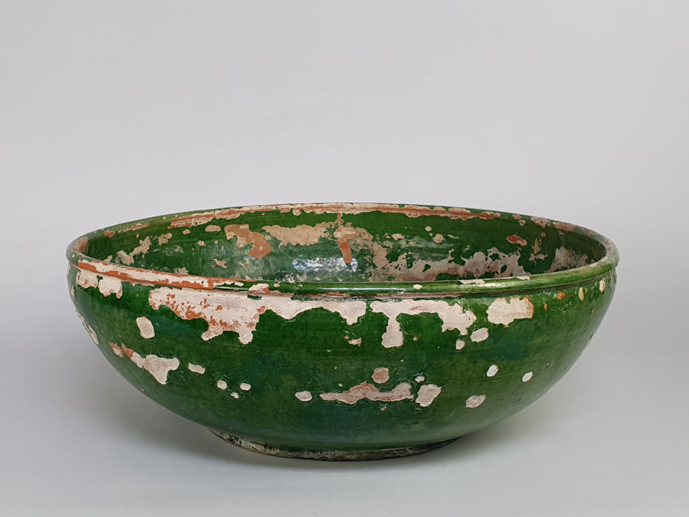 Rustic antique pottery Bowl with a worn green glaze