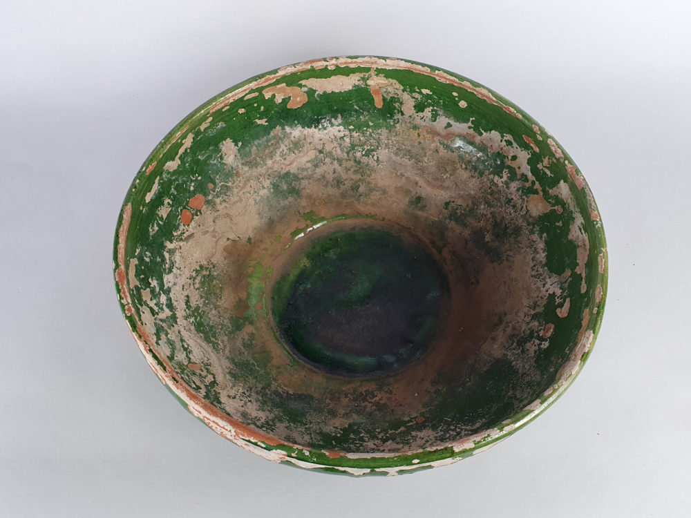 Rustic antique pottery Bowl with a worn green glaze
