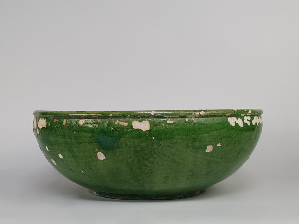 Rustic antique pottery Bowl with a worn green glaze
