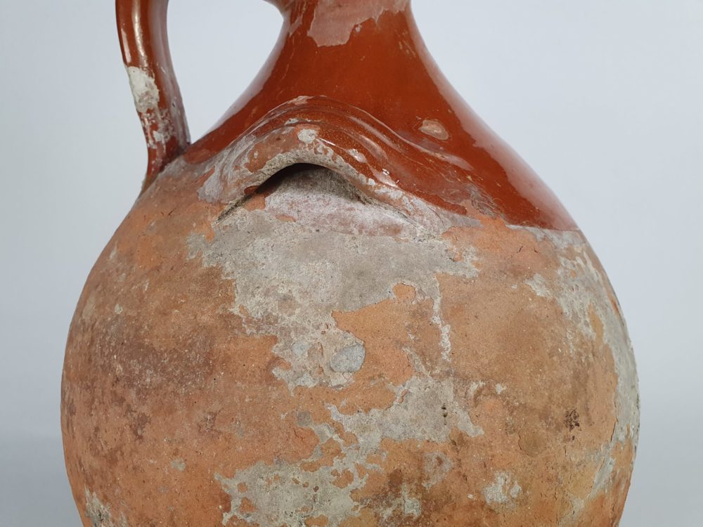 Rustic antique terracotta pottery Amphora with a worn russet glaze