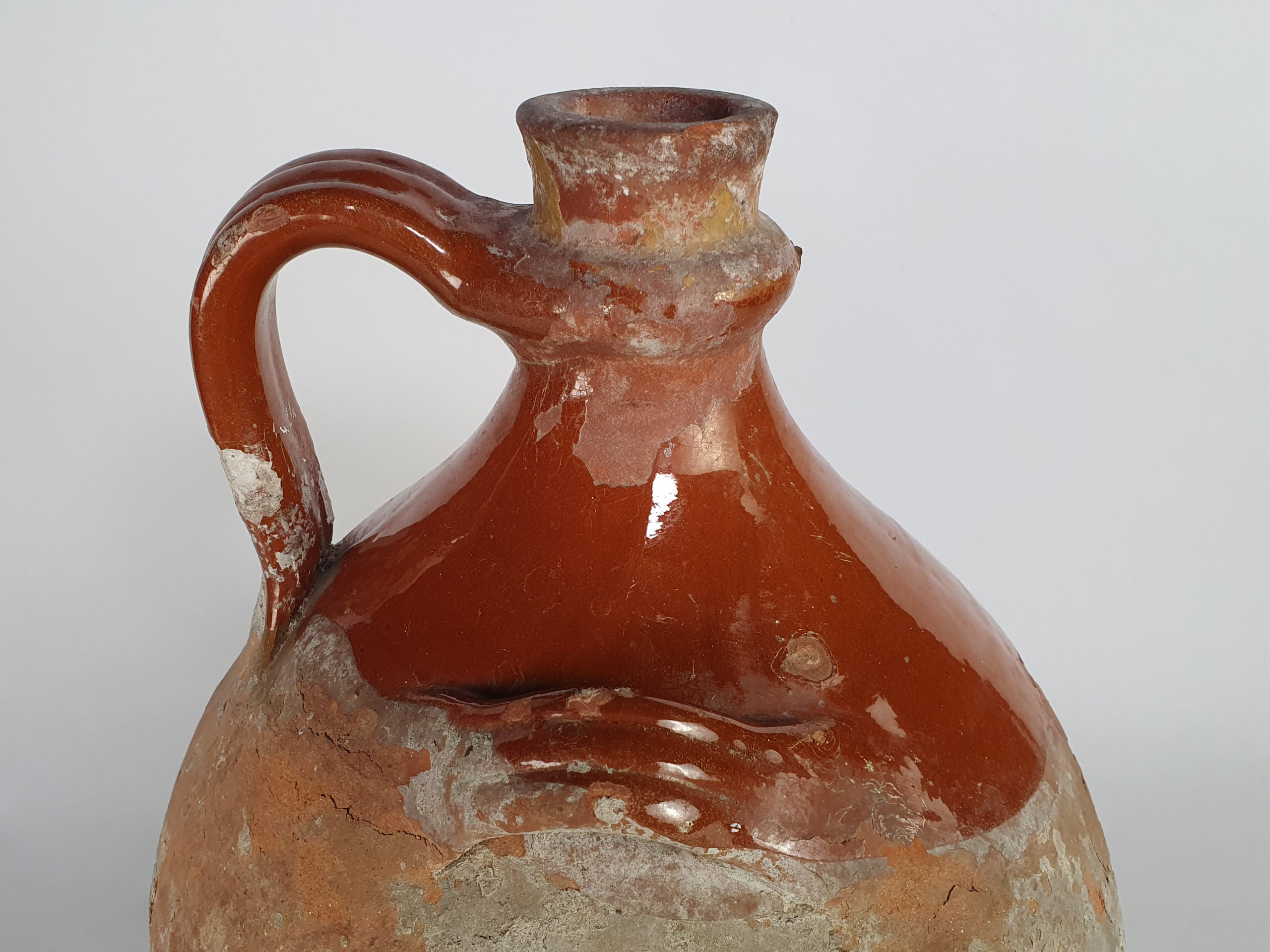 Rustic antique terracotta pottery Amphora with a worn russet glaze