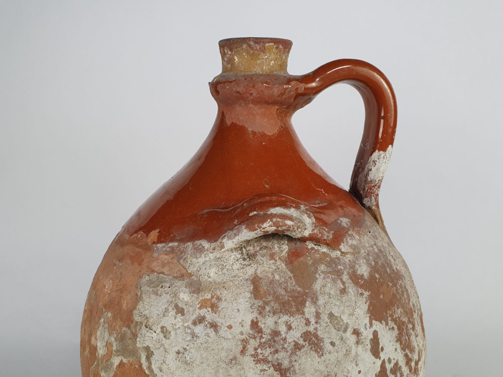 Rustic antique terracotta pottery Amphora with a worn russet glaze