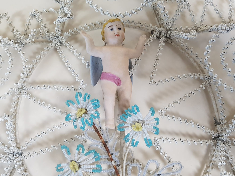 Star shaped antique Bead Work Wreath with Cherub