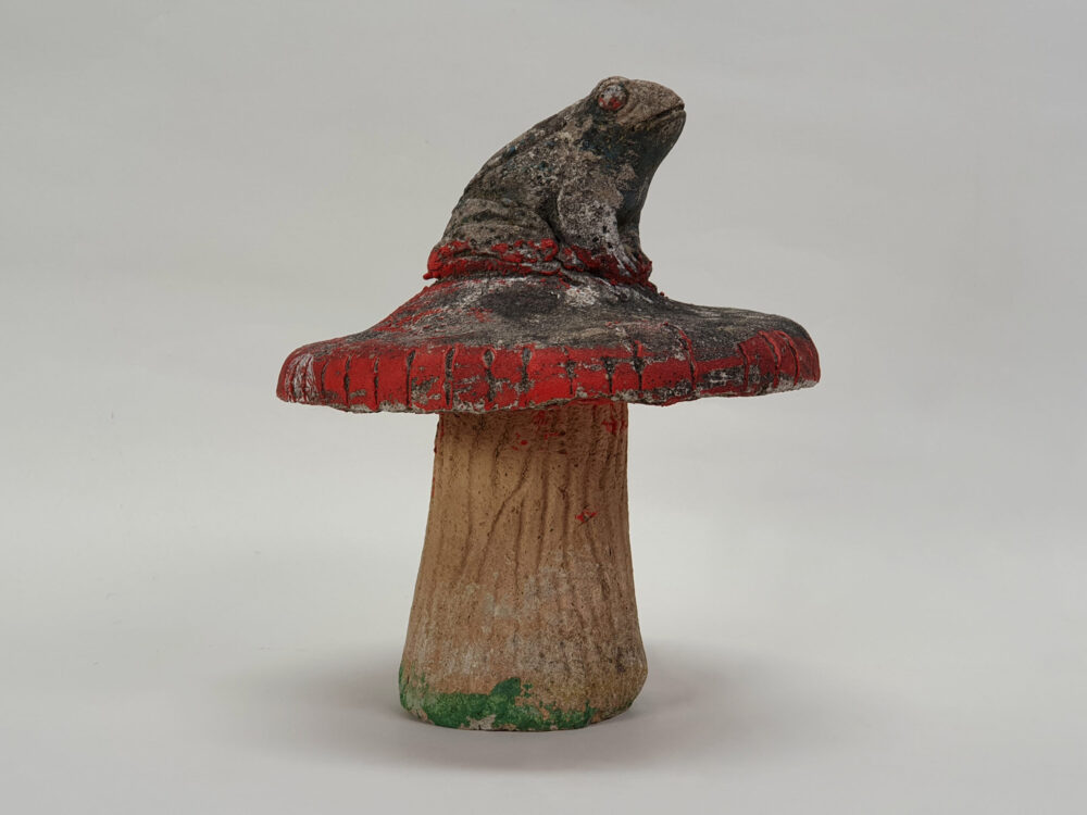 Toad sitting on toadstool - antique garden Ornament