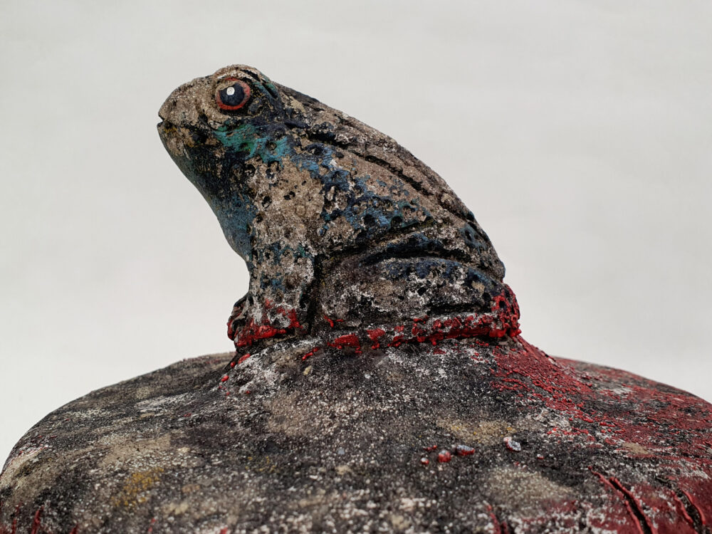 Toad sitting on toadstool - antique garden Ornament