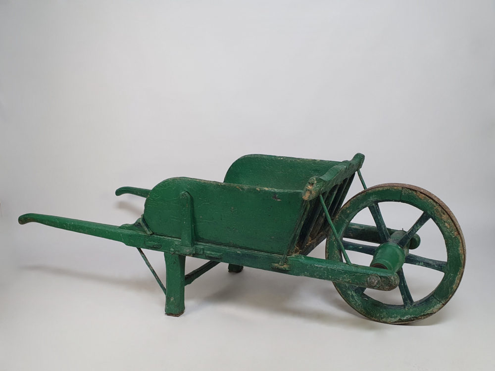 Antique garden wheelbarrow in original green paint
