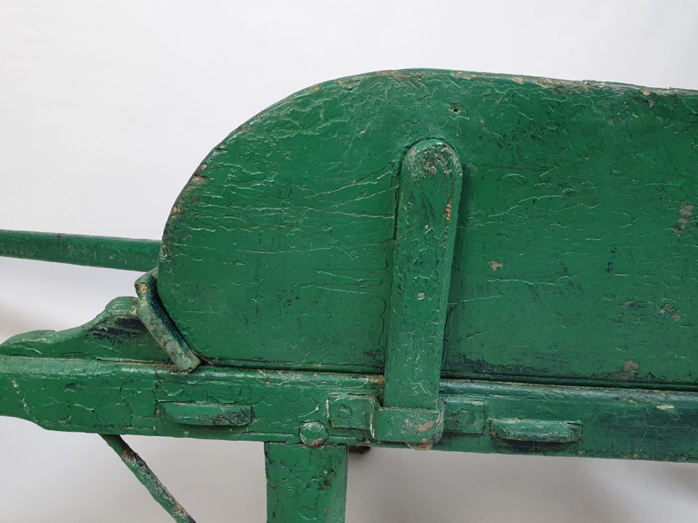Antique garden wheelbarrow in original green paint